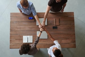 Four people collaborating around a table