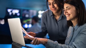 two women working on a laptop